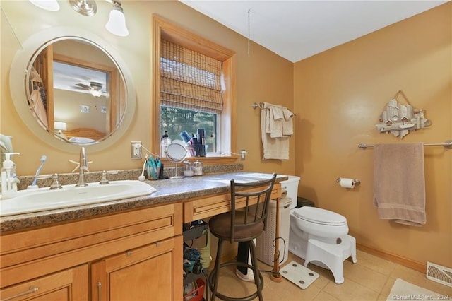 bathroom with ceiling fan, tile flooring, large vanity, and toilet