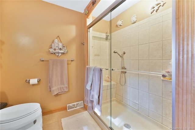 bathroom with walk in shower, tile floors, and toilet