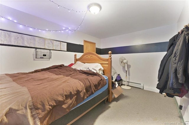 bedroom with a baseboard heating unit and carpet