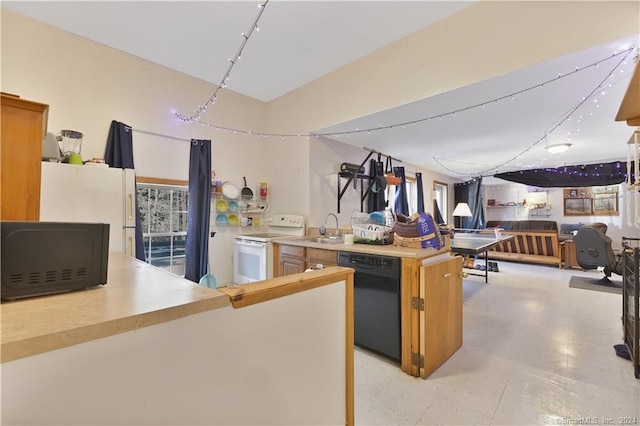 kitchen featuring a kitchen island, sink, light tile floors, and black appliances