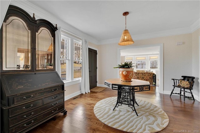 dining room with crown molding and hardwood / wood-style flooring