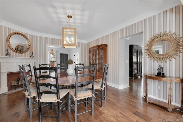 dining area with crown molding, a notable chandelier, and dark hardwood / wood-style floors