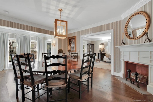 dining area with an inviting chandelier, dark hardwood / wood-style floors, and ornamental molding