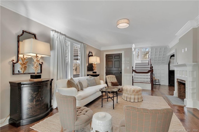 living room featuring ornamental molding and dark wood-type flooring