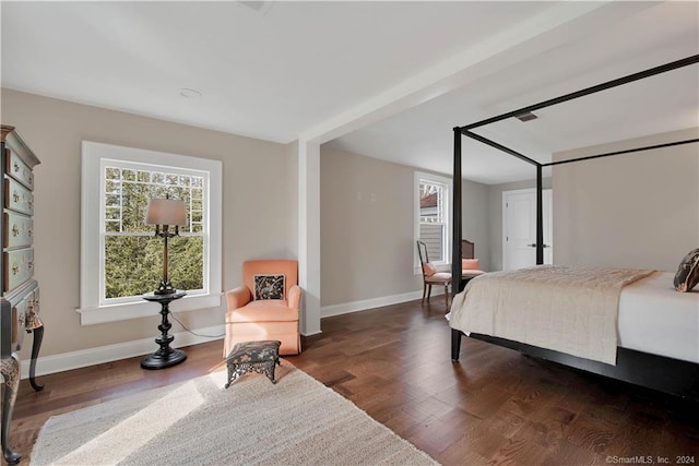 bedroom with dark wood-type flooring