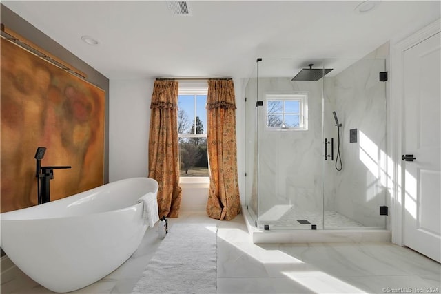 bathroom with independent shower and bath and tile flooring