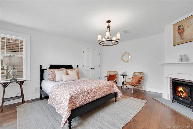 bedroom with a notable chandelier and wood-type flooring