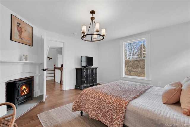 bedroom with a chandelier and light wood-type flooring