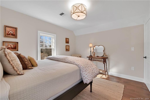 bedroom with dark wood-type flooring