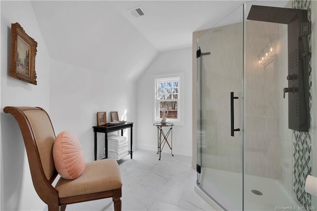 bathroom with a shower with shower door, tile flooring, and vaulted ceiling