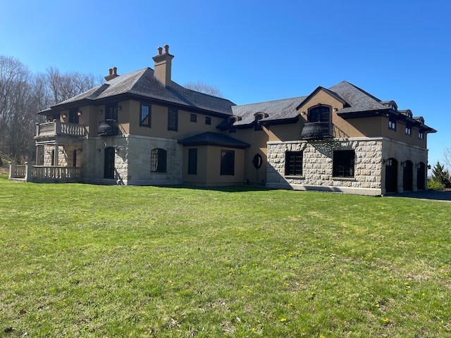 rear view of property with a yard