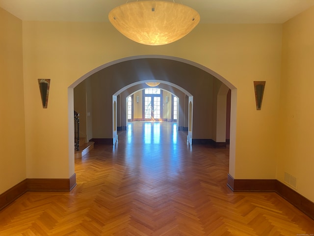 unfurnished room featuring parquet flooring