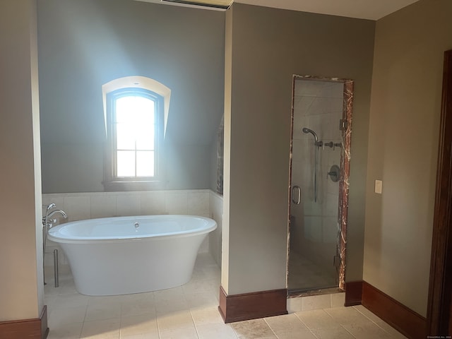 bathroom featuring plus walk in shower and tile floors