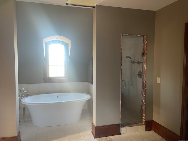 bathroom featuring tile floors and independent shower and bath