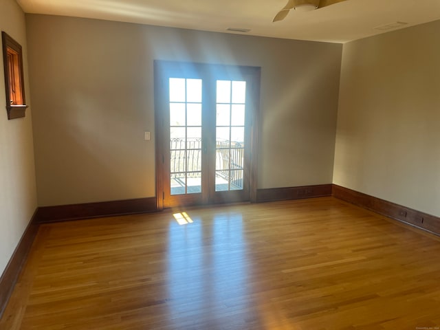 spare room with ceiling fan and light wood-type flooring