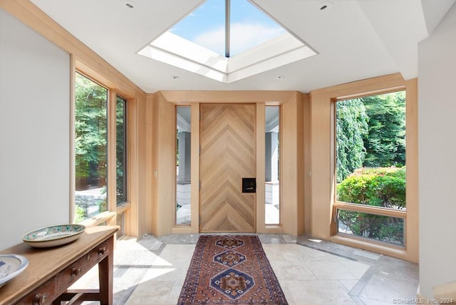 entryway with plenty of natural light, a skylight, and light tile flooring