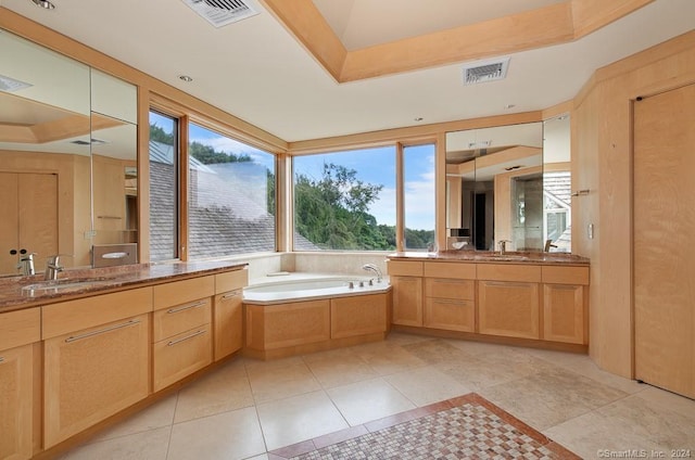 bathroom featuring vanity, tile flooring, and a washtub