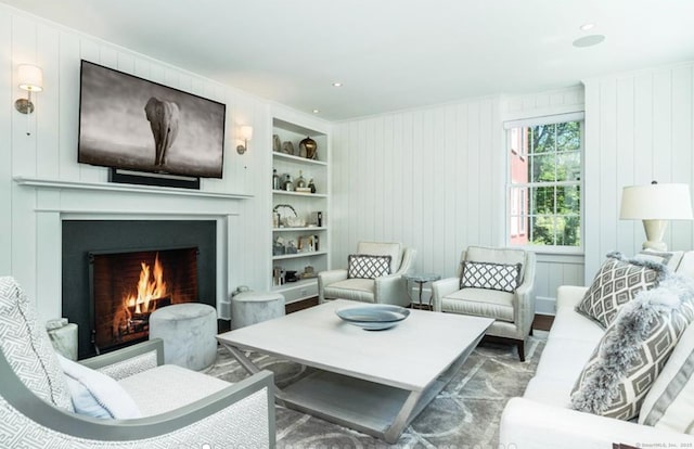 living area with built in shelves and a fireplace