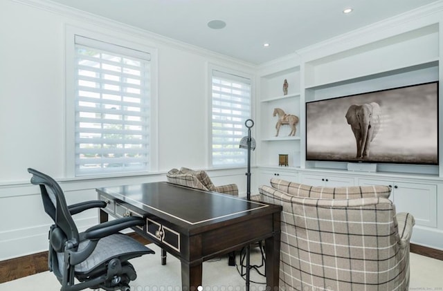 home office featuring built in shelves, crown molding, recessed lighting, a decorative wall, and wood finished floors