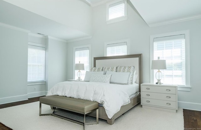 bedroom featuring ornamental molding, multiple windows, and baseboards