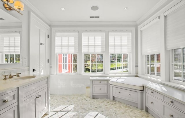 unfurnished sunroom with visible vents and a sink