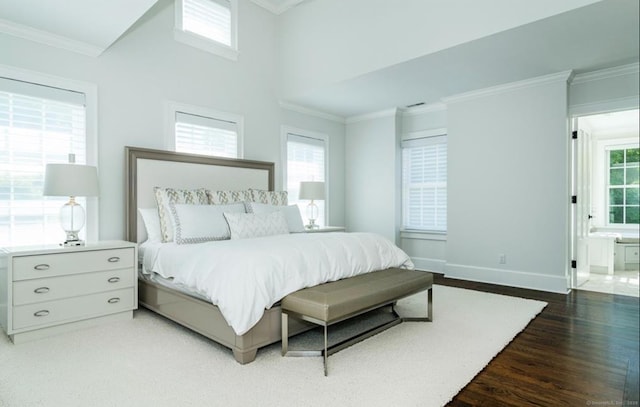 bedroom with baseboards, dark wood finished floors, and crown molding