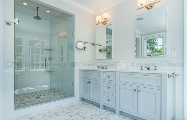 full bathroom featuring double vanity, ornamental molding, a shower stall, and tile walls