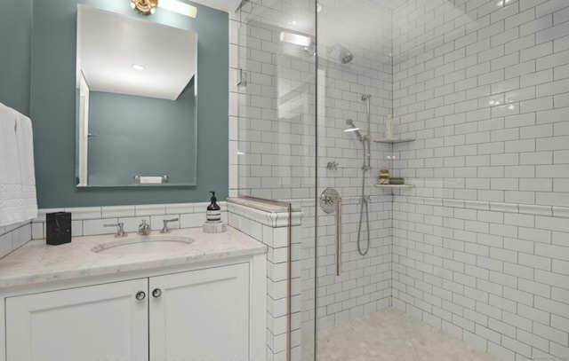 full bathroom with a shower stall and vanity