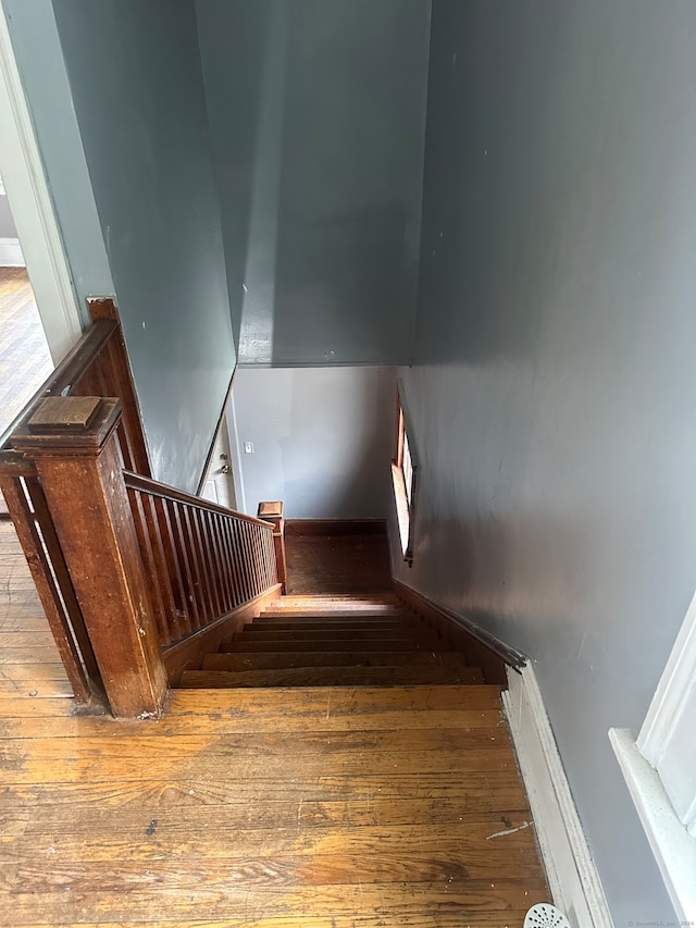 stairs with hardwood / wood-style flooring