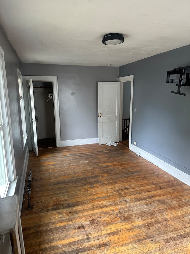 unfurnished room featuring dark hardwood / wood-style flooring