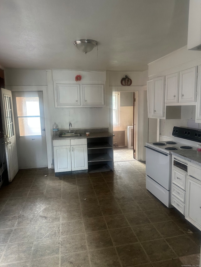 kitchen with sink, white electric stove, and white cabinetry