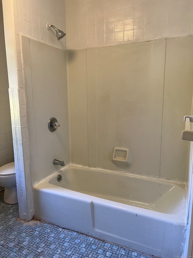 bathroom featuring bathing tub / shower combination and toilet