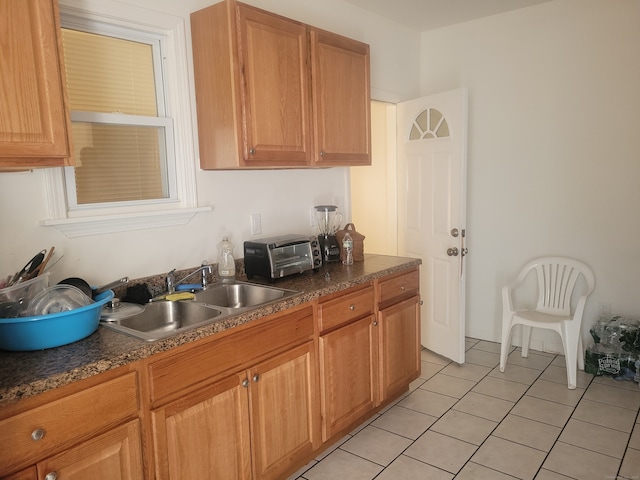 kitchen with light tile floors and sink