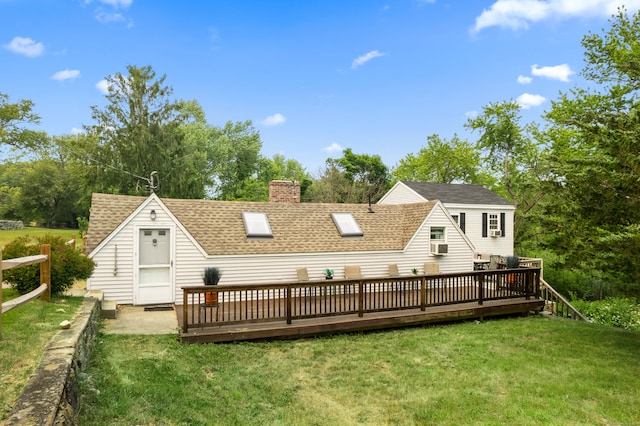 back of house with a deck and a yard