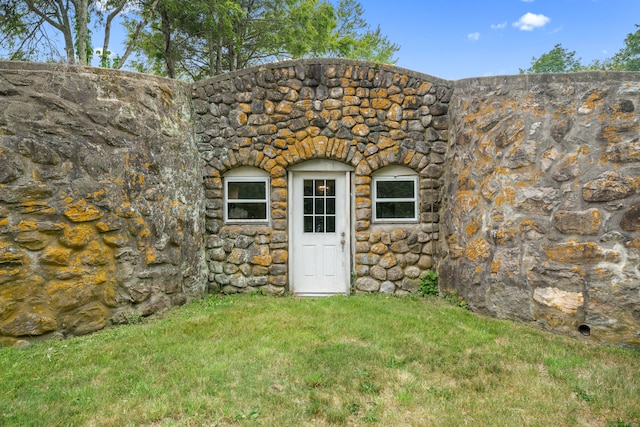 entrance to property with a lawn