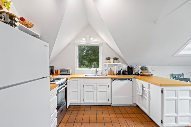 kitchen with lofted ceiling, white appliances, sink, and white cabinetry