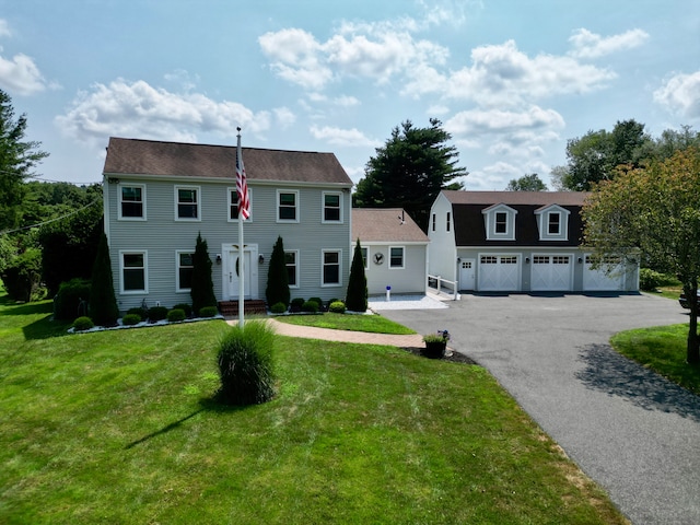 colonial-style house with a front lawn and a garage