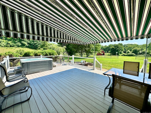 wooden deck with a hot tub and a yard