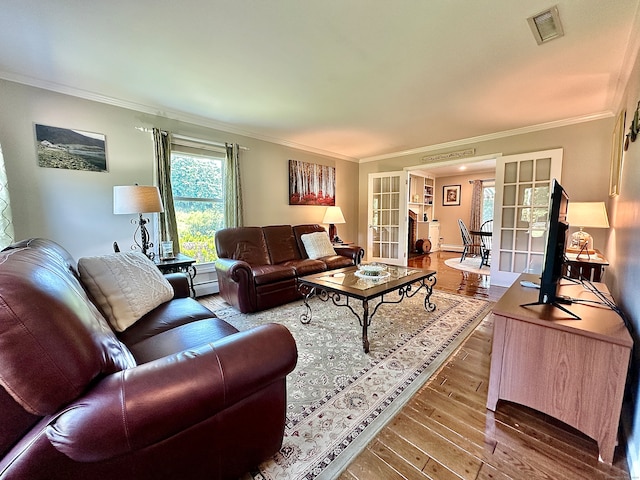 living room featuring crown molding, french doors, and hardwood / wood-style flooring