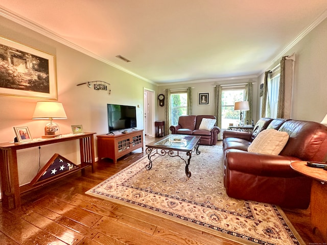 living room with wood-type flooring and ornamental molding