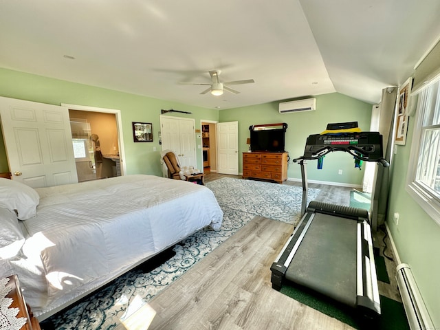 bedroom with ceiling fan, an AC wall unit, vaulted ceiling, and multiple windows