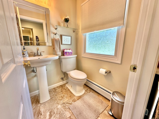 bathroom with a baseboard heating unit, tile patterned floors, and toilet