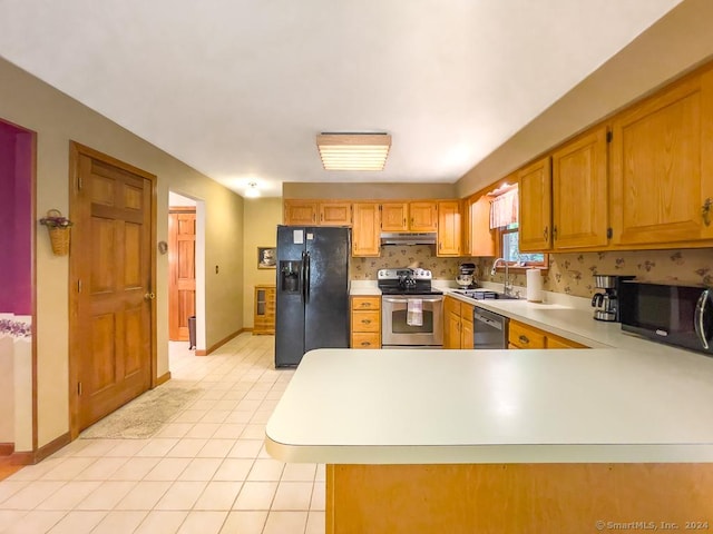 kitchen featuring kitchen peninsula, sink, light tile patterned floors, and stainless steel appliances