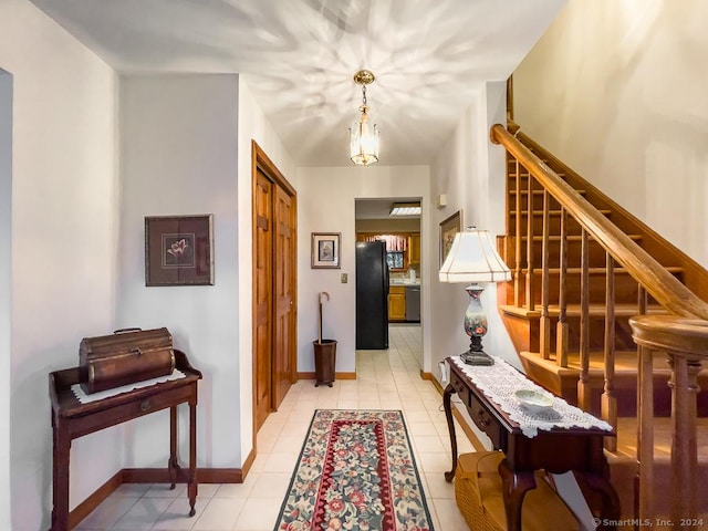 corridor featuring an inviting chandelier and light tile patterned flooring