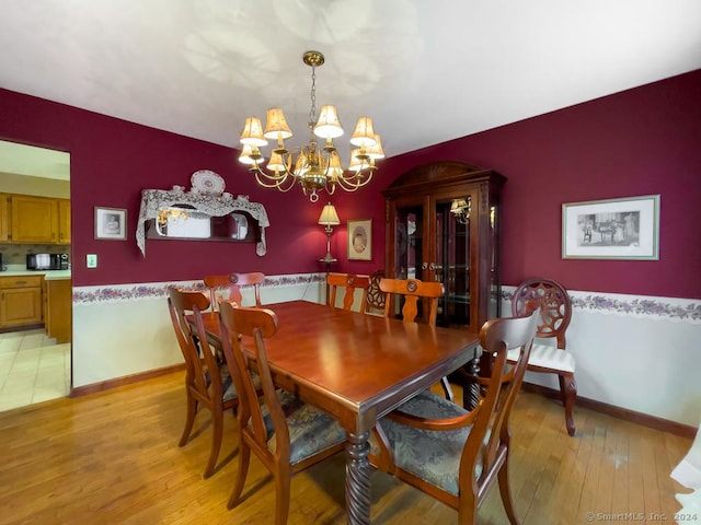 dining room featuring a chandelier and light wood-type flooring