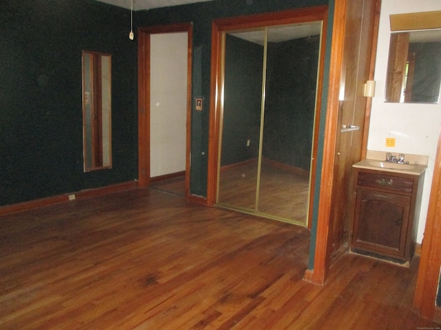 interior space with sink and dark wood-type flooring