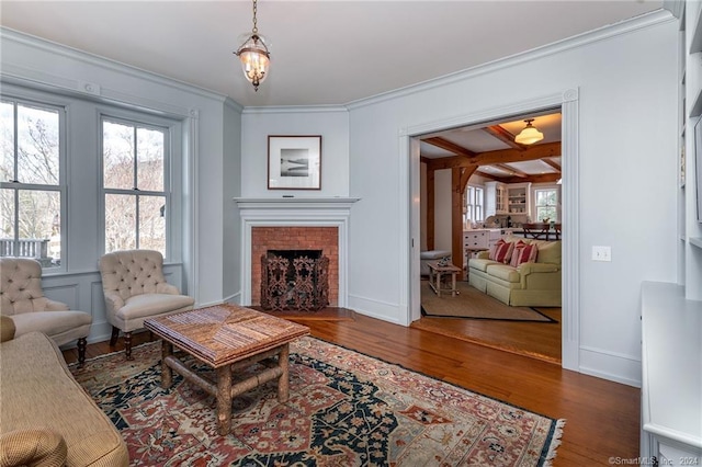 living room featuring dark wood-type flooring, plenty of natural light, beam ceiling, and a notable chandelier