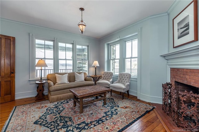 living room featuring ornamental molding, a brick fireplace, and hardwood / wood-style flooring