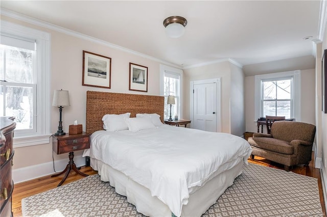 bedroom with multiple windows, a closet, and light hardwood / wood-style floors