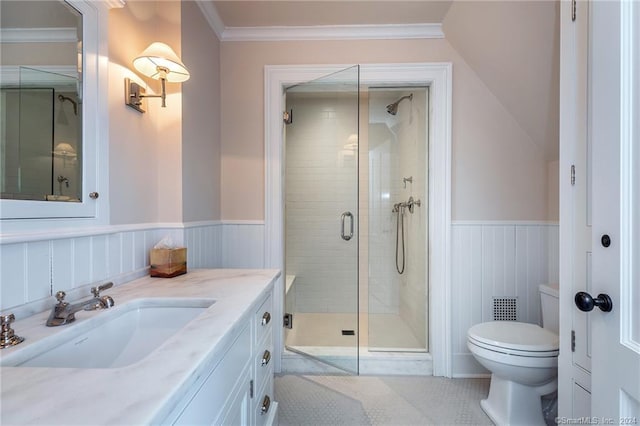 bathroom with toilet, tile patterned flooring, ornamental molding, vanity, and a shower with door